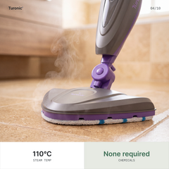 Close-up of the mop head gliding across beige floor tiles, with visible steam rising from the microfiber pad.